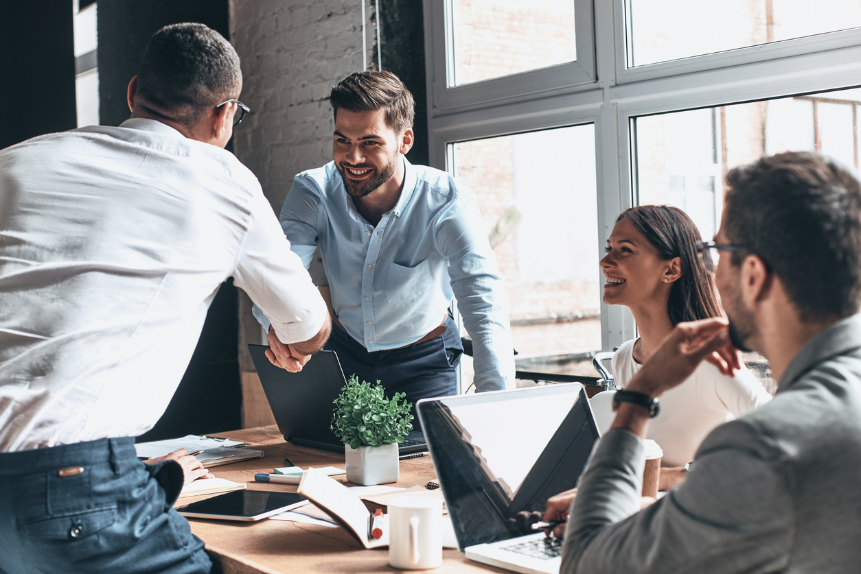 Business people in meeting shaking hands